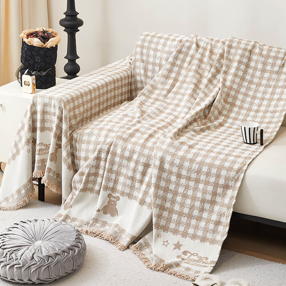 Copertura per divano in chenille con motivo retro a quadretti, con frange decorative.
