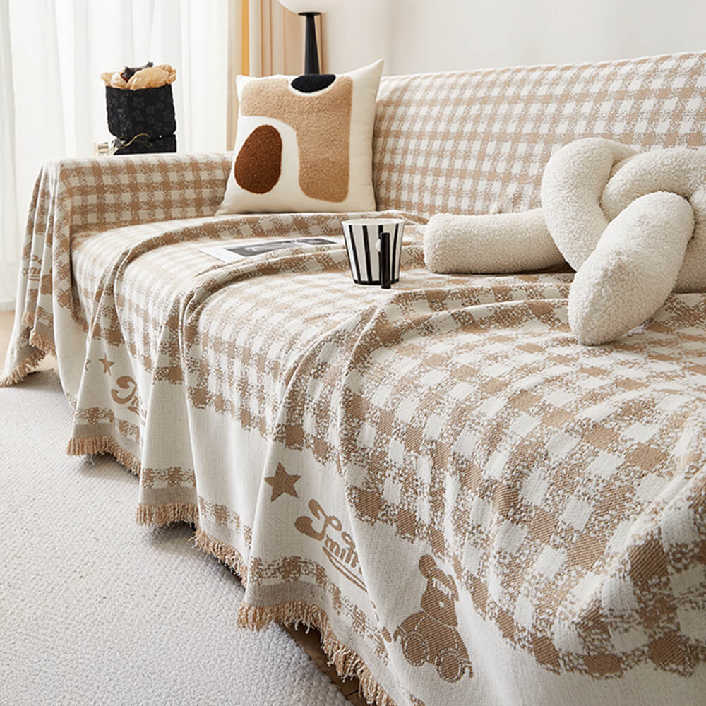 Copertura per divano in chenille con motivo retro a quadretti, con frange decorative.