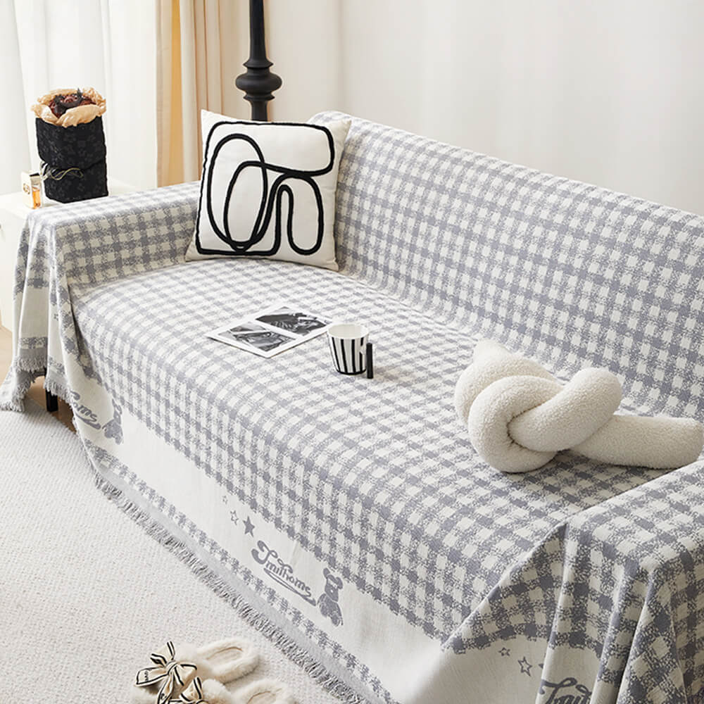 Copertura per divano in chenille con motivo retro a quadretti, con frange decorative.