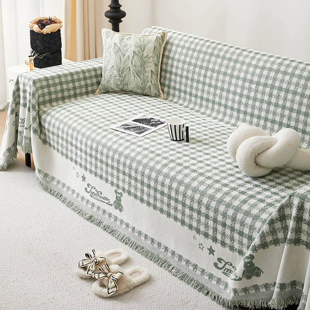 Copertura per divano in chenille con motivo retro a quadretti, con frange decorative.