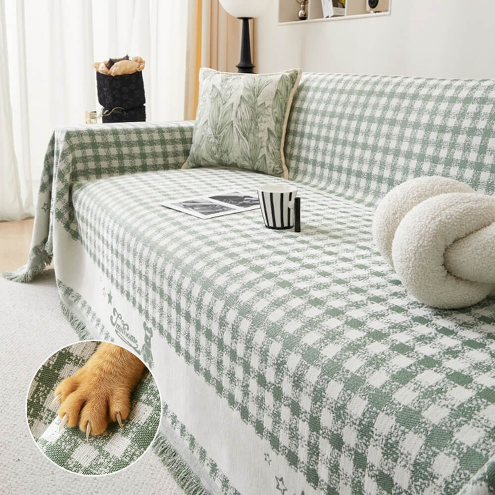 Copertura per divano in chenille con motivo retro a quadretti, con frange decorative.