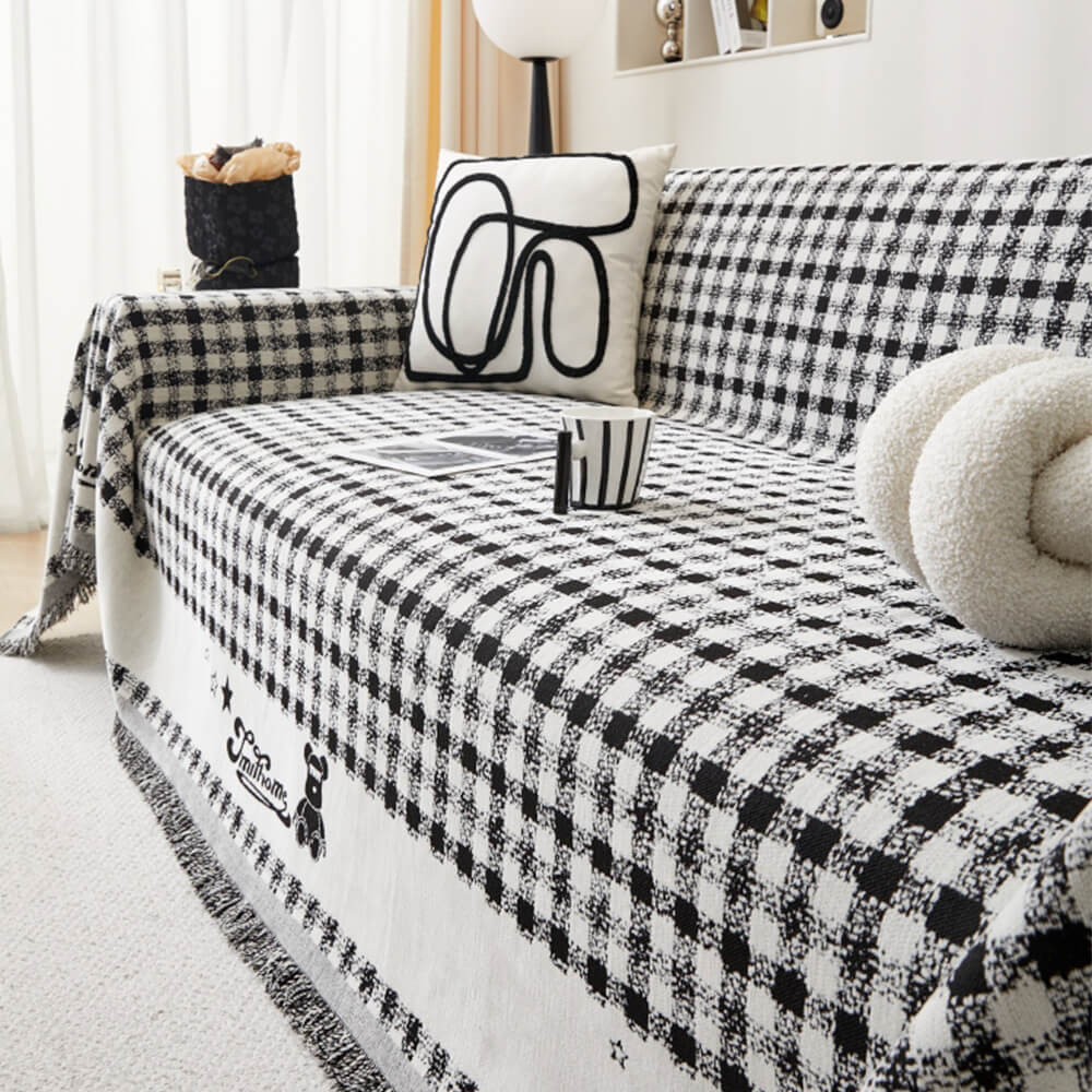 Copertura per divano in chenille con motivo retro a quadretti, con frange decorative.
