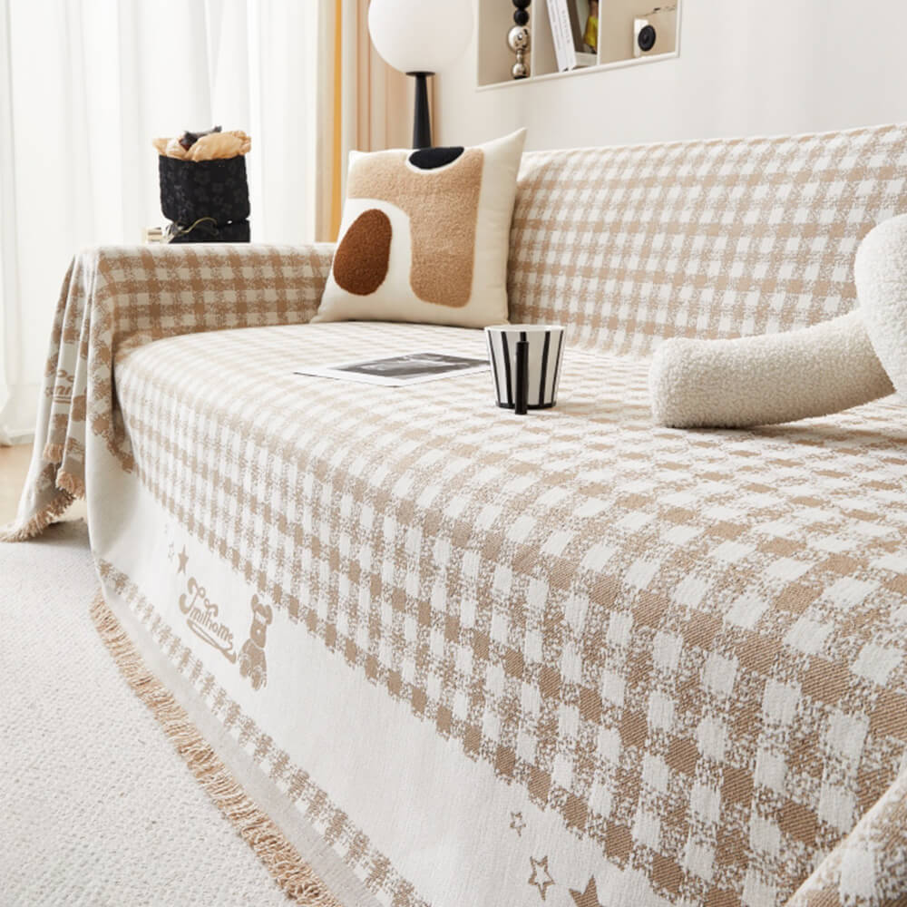 Copertura per divano in chenille con motivo retro a quadretti, con frange decorative.