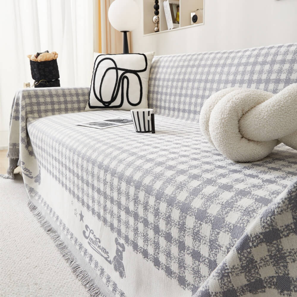 Copertura per divano in chenille con motivo retro a quadretti, con frange decorative.