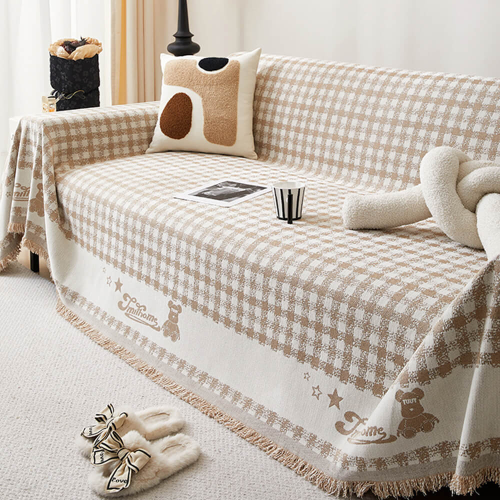 Copertura per divano in chenille con motivo retro a quadretti, con frange decorative.