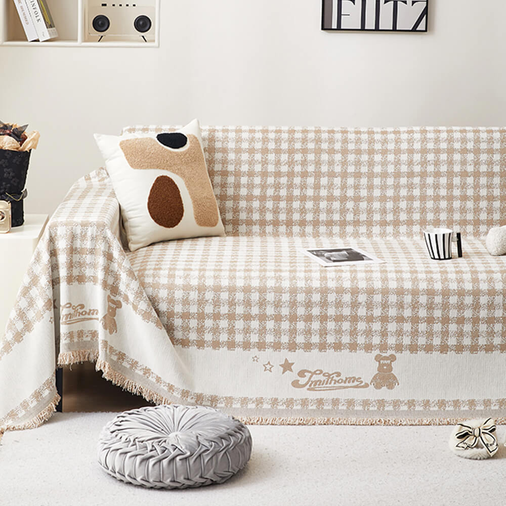 Copertura per divano in chenille con motivo retro a quadretti, con frange decorative.