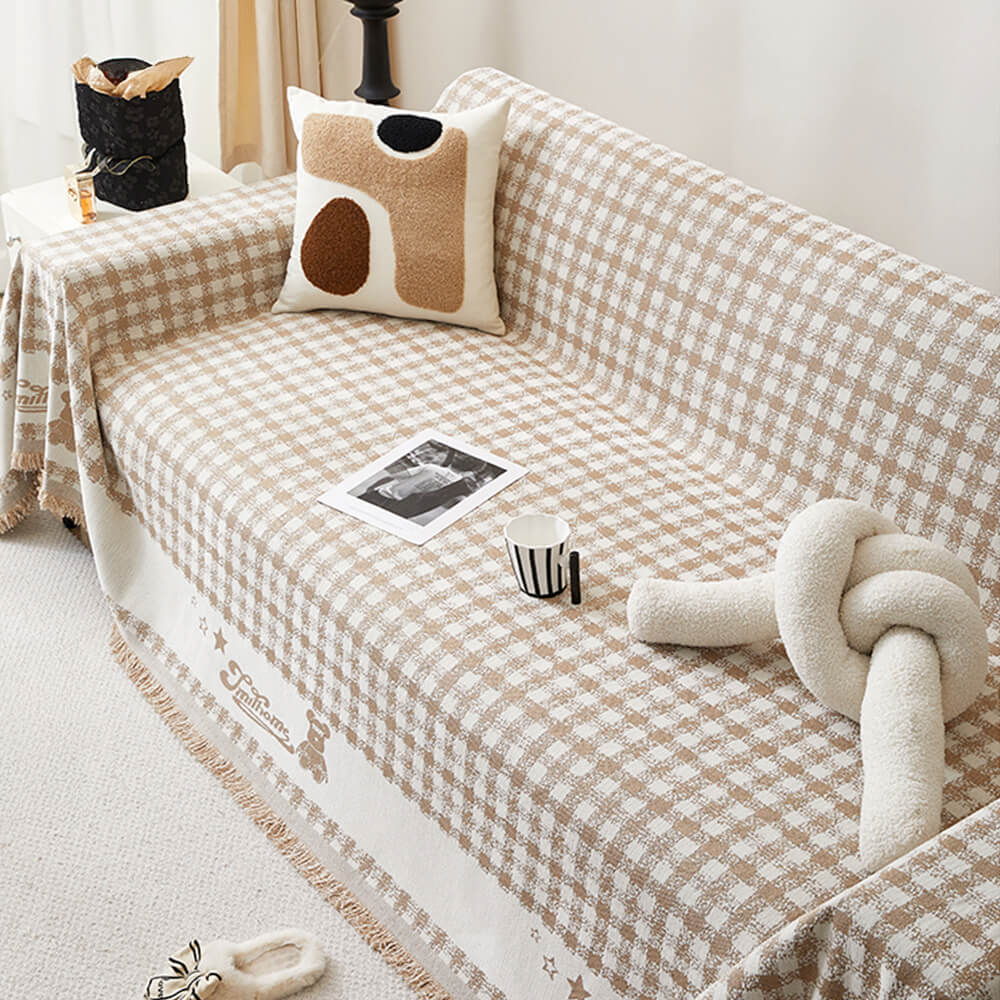 Copertura per divano in chenille con motivo retro a quadretti, con frange decorative.